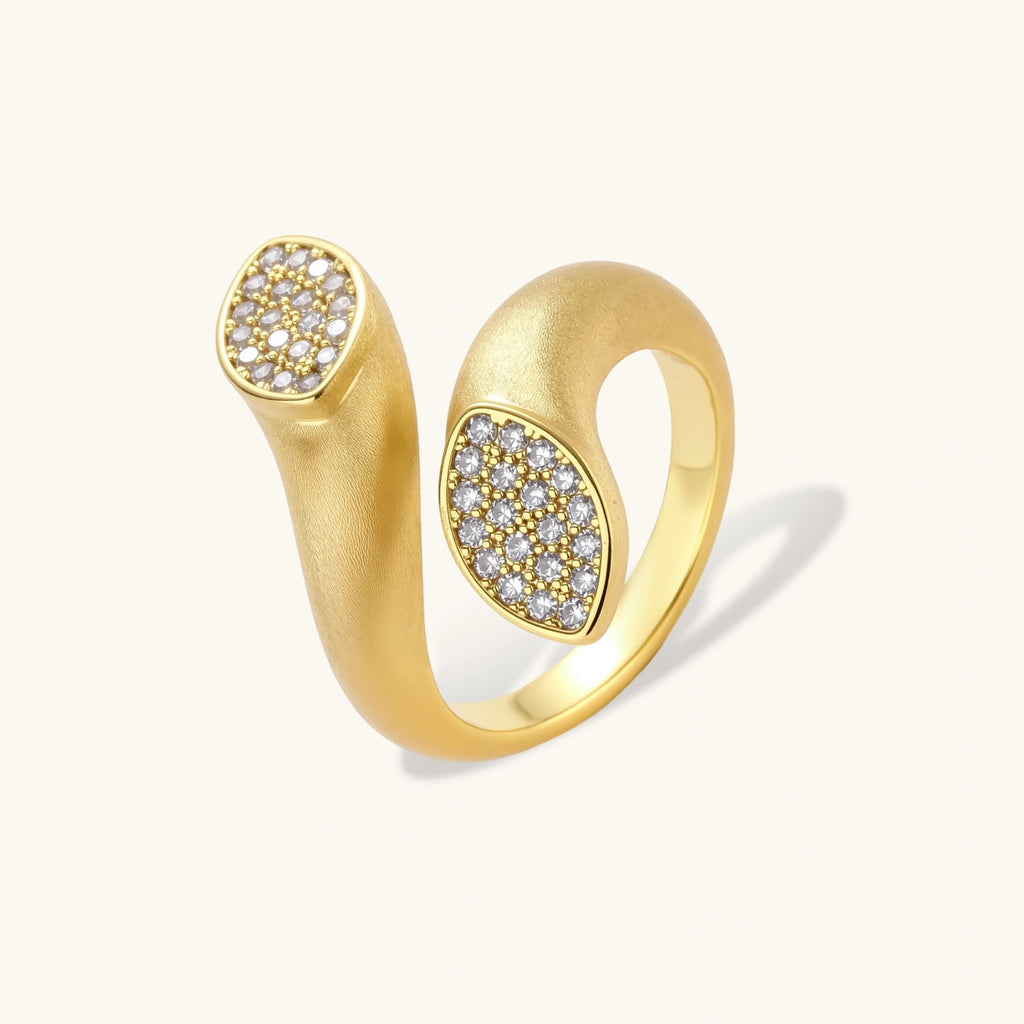 Gold ring with diamond accents on a white background