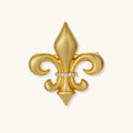 Gold fleur-de-lis broach pin with crystal center on a white background