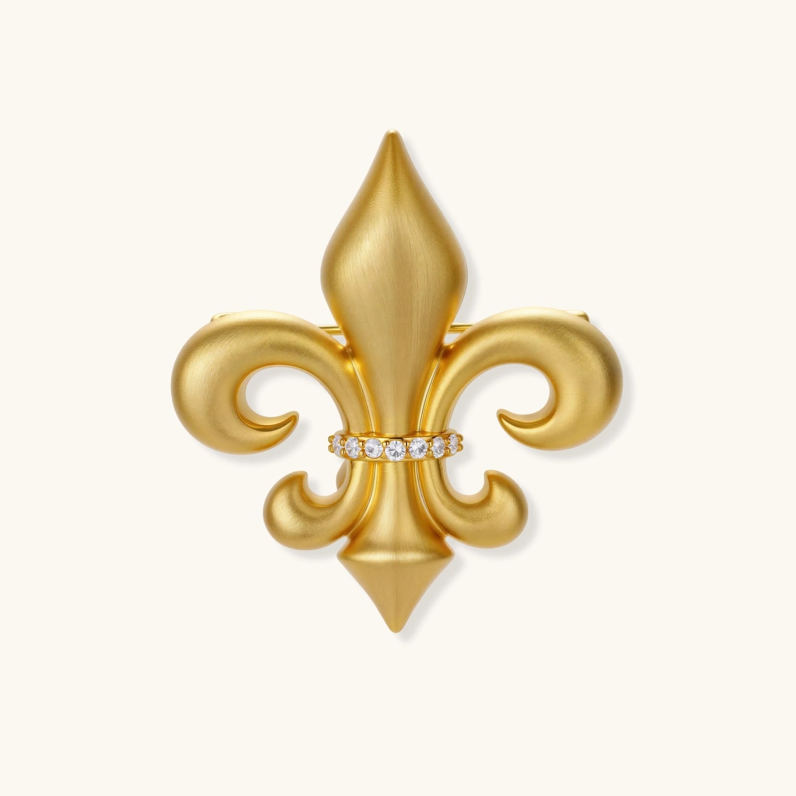 Gold fleur-de-lis broach pin with crystal center on a white background