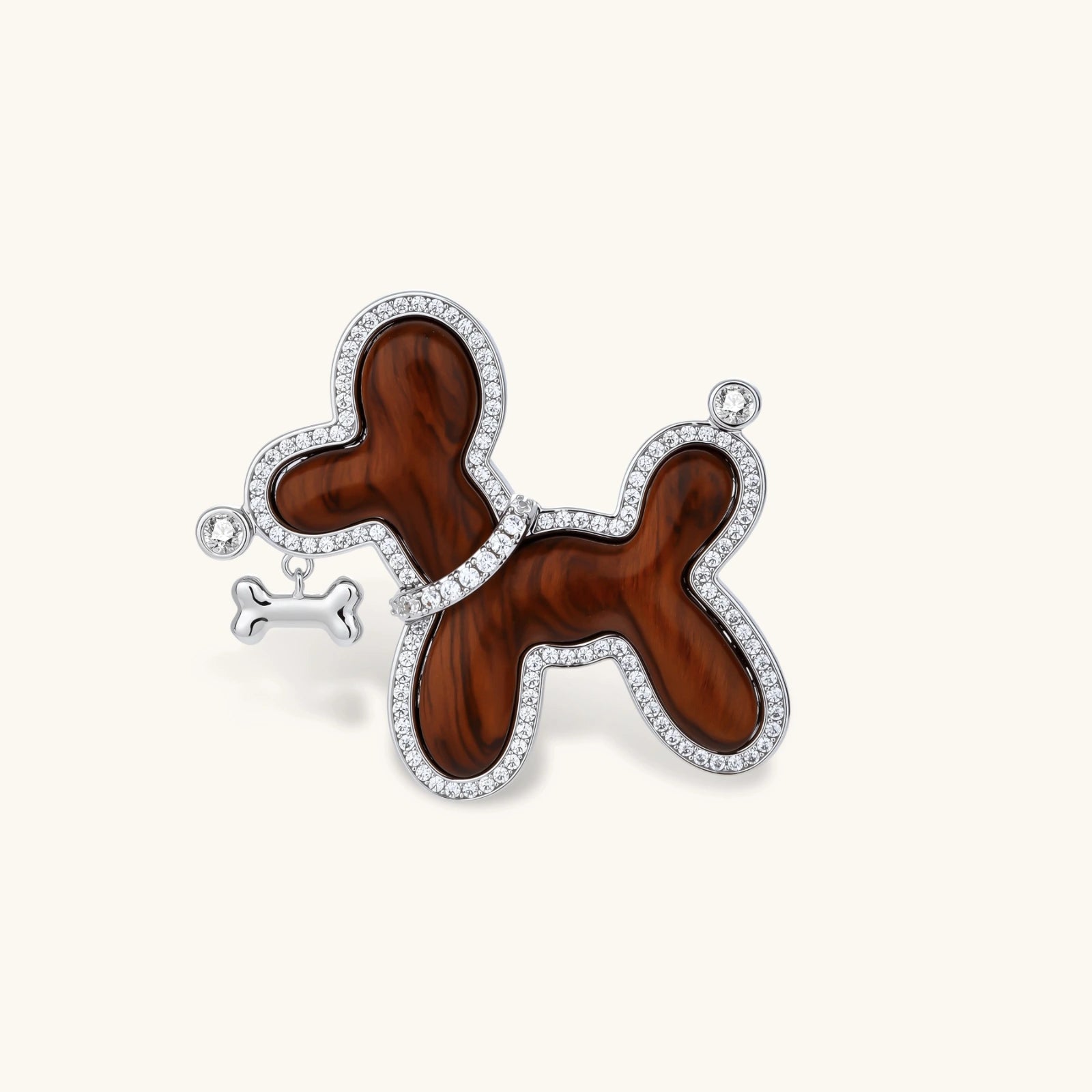 Wooden balloon dog pendant with silver accents on a white background