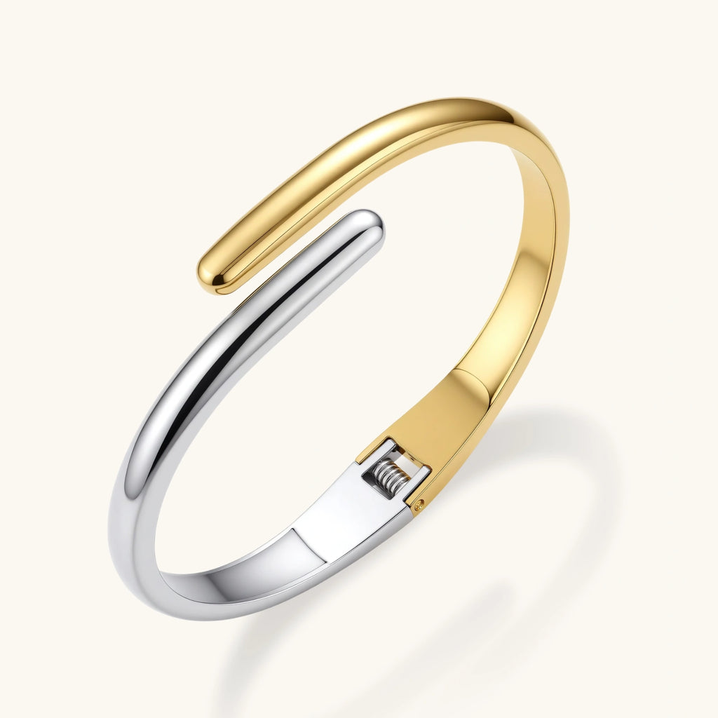 Gold and silver bangle on a white background
