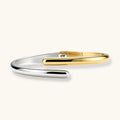 Two-toned gold and silver bracelet on a white background