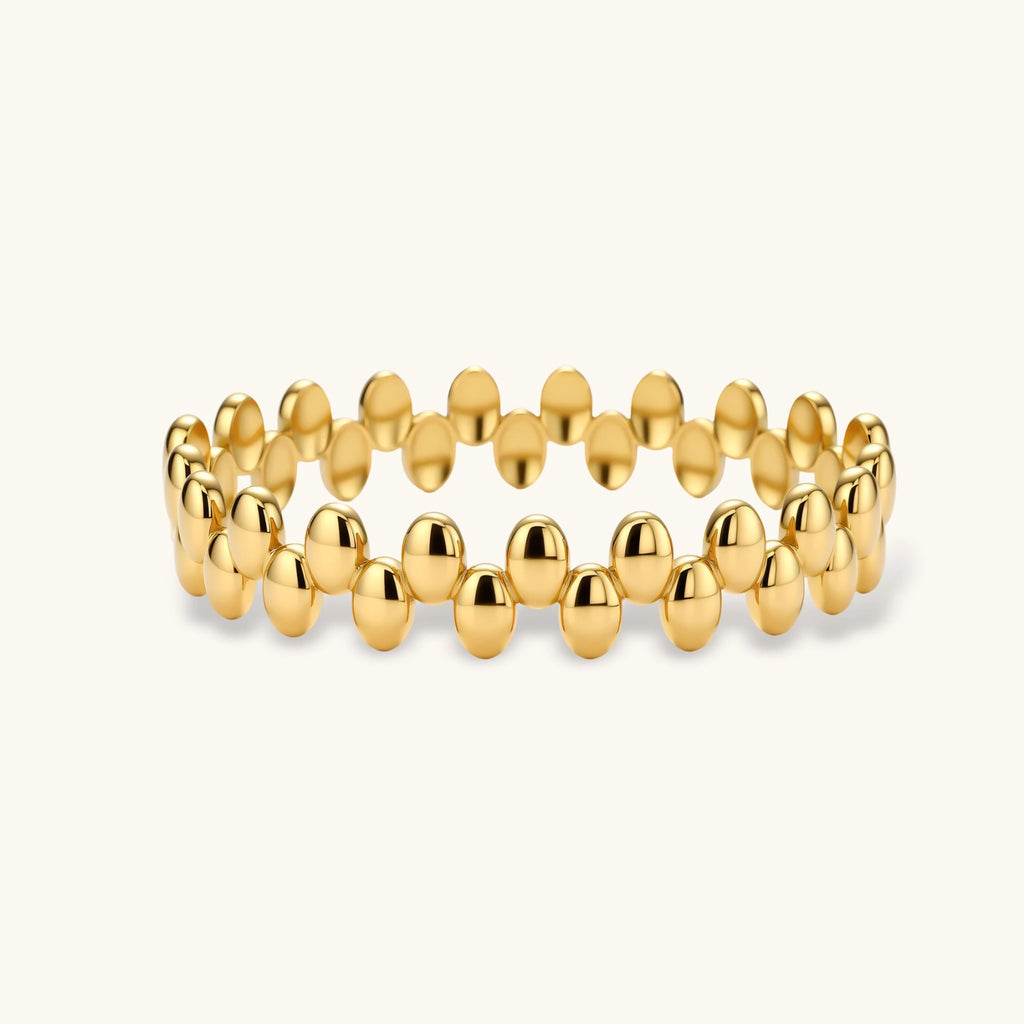 Gold beaded bracelet on a white background