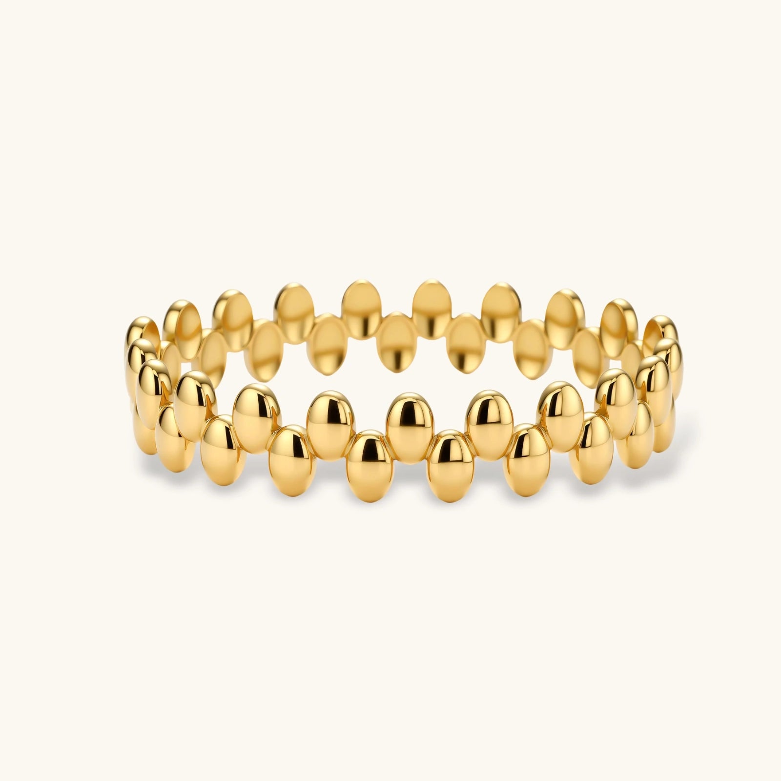 Gold beaded bracelet on a white background