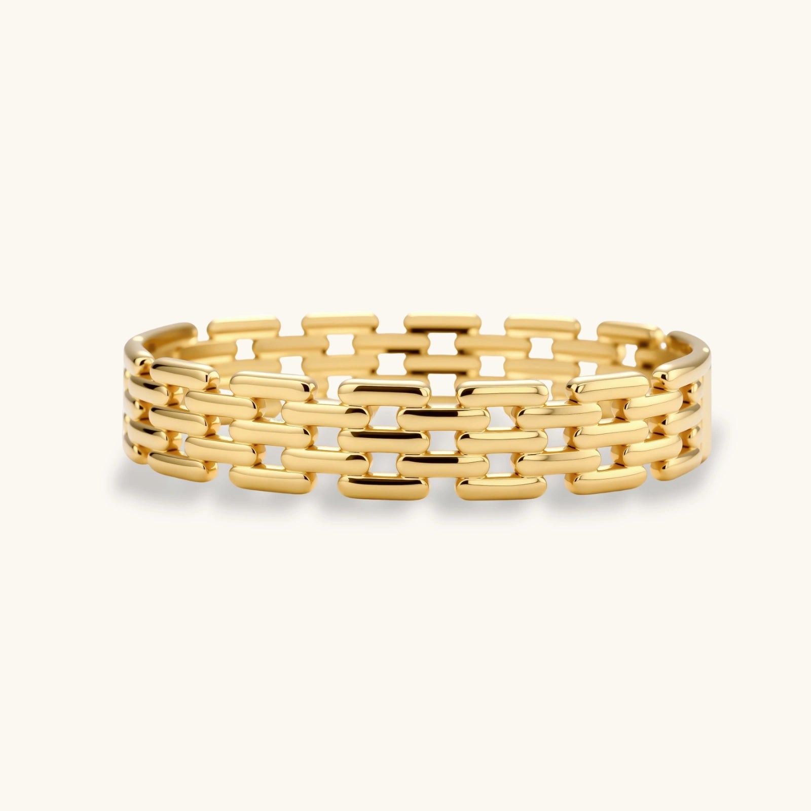 Gold bracelet with a geometric pattern on a white background