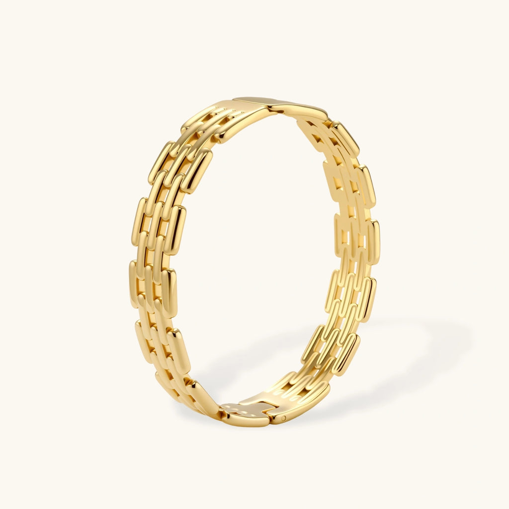 Gold bracelet with a chain-like design on a white background