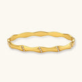 Gold bracelet with small stones on a white background