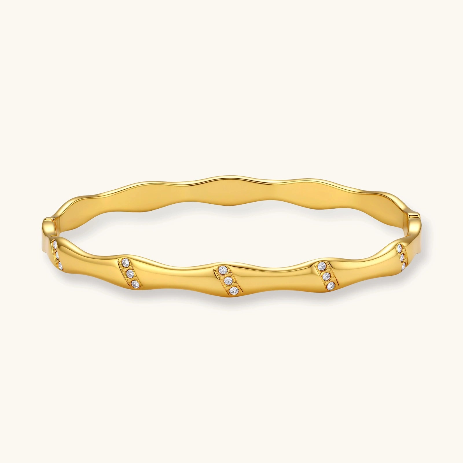 Gold bracelet with small stones on a white background