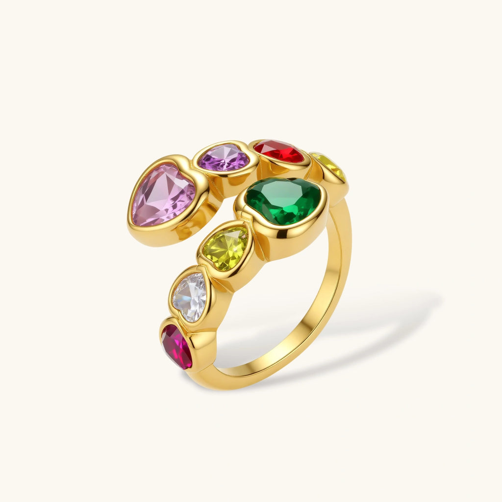 Gold ring with colorful gemstones on a white background
